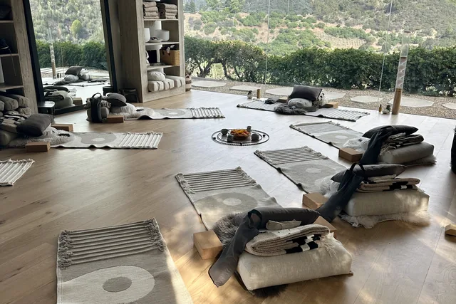 The practice space at Casa Sangha set up with mats, cushions and blankets