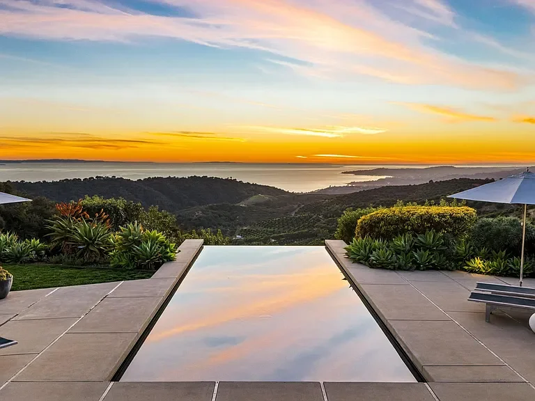 The infinity pool at Casa Sangha at sunset, looking out to the Pacific